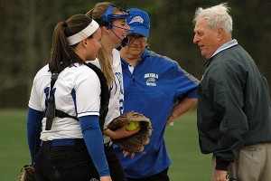 Home plate umpire George Gaspa, St. John Paul II head softball coach Mike Manley and Lions' catcher Hadley Tate go out to the mound to check on pitcher Jackie Smith who took a line drive off her throwing hand against Mashpee Wednesday. Sean Walsh/Capecod.com Sports