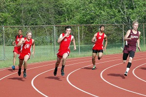 Falmouth High's Tristan Meacham burns past Barnstable's Sean Dumais and Ryan Chevalier in the boys' 200m race yesterday at Barnstable High. Sean Walsh/Capecod.com Sports