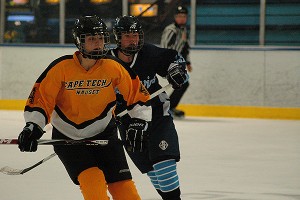 Sandwich junior forward Christina O'Neil (23) comes up from behind Nauset/Cape Tech's Amanda Rich in third period action Friday night  at the Charles Moore Arena. O'Neil scored the last goal of the game with just 3:00 left in the third period to make it 7-2. Sean Walsh/www.capecod.com sports