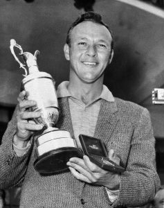 File-This July 15, 1961, file photo shows Arnold Palmer smiling with his trophy and medal after winning the British Open Golf Championship by a single stroke at Royal Birkdale course in Birkdale, Lancashire, England. Palmer, who made golf popular for the masses with his hard-charging style, incomparable charisma and a personal touch that made him known throughout the golf world as "The King," died Sunday, Sept. 25, 2016, in Pittsburgh. He was 87. (AP Photo, File)