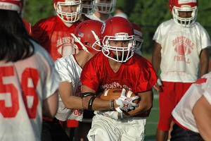 Barnstable High School's Ryan Dauphinais takes the hand-off from Colton Bergal at Barnstable High's first football practice of the 2015 season Monday night in Hyannis. Sean Walsh/Capecod.com Sports