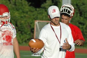 Barnstable High School head football coach Chris Whidden goes over assigments on the first day of football practice Monday night at W. Leo Shields Memorial Field. Sean Walsh/Capecod.com Sports