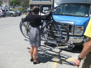 CCB MEDIA PHOTO An event attendee being shown how to place a bike on a bike rack on the front of a ccrta vehicle.