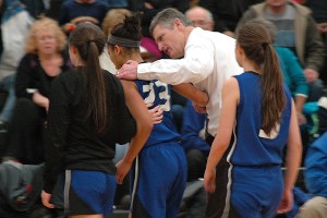 Falmouth Academy head coach Gus Adams consoles  Kendall Currence as she comes out of the game near the end of the fourth quarter in last night's 68-40 tournament loss. Sean Walsh/Capecod.com Sports