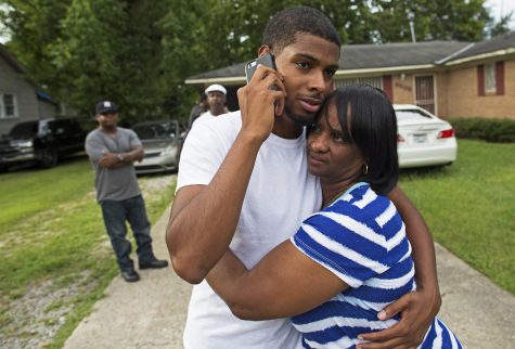Beverly Blakes, the aunt of fallen Baton Rouge policeman Montrell Jackson, hugs Kedrick Pitts, the half-brother of slain Baton Rouge Policeman, Cpl. Jackson, after visiting Montrell's mother's house in Baton Rouge, La., Sunday, July 17, 2016. Jackson was one of the law enforcement officers who were shot and killed on Sunday morning. (AP Photo/Max Becherer)