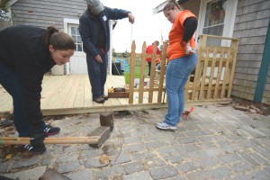 CCB MEDIA PHOTO Volunteer laborers and skilled workers rebuild Betsie Tracey's back walkway in Buzzards Bay Saturday, as part of the 2015 Big Fix