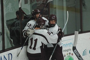 Falmouth senior captain Arlin Moore (9) and sophomore Cooper Rogers celebrate with Nick Marston after he scored to make it 3-1 in Saturday night's 6-1 loss for the Clippers to Catholic Memorial. Sean Walsh/CCBM Sports