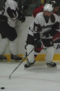 Falmouth junior defenseman Abby Peterson (10) goes for the puck in Saturday night's 4-0 victory over Hingham.  Sean Walsh/CCBM Sports