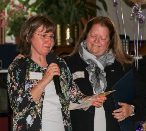 COURTESY OF THE FAMILY PANTRY OF CAPE COD President Amy Camenga, right, presents Mary Anderson with a proclamation from State Senator Dan Wolf and Senate President Stan Rosenberg.