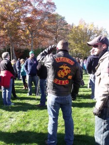 Volunteers gather before placing flags at graves at the Massachusetts national Cemetery in Bourne. Photo by Cat Wilson.