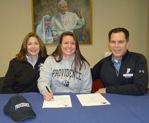 St. John Paul II High School senior softball captain Hadley Tate signed her letter of intent to play for the Providence College Friars next fall. She's seated here with her parents Nancy and Al Tate of Barnstable. Photo courtesy of SJPII Athletics
