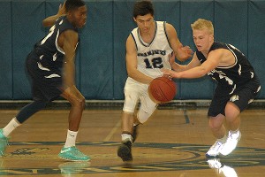 Cape Cod Academy's Johnny Hatem tries to split Nantucket defenders Fervon Phillips and Ryan Allen in last night's 62-52 barnburner at the Thomas Evans Gymnasium in Osterville. Sean Walsh/CCBM Sports
