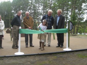 CCB MEDIA PHOTO Samantha Goode, a fifth grade student at Nathaniel H. Wixon Innovation School, cuts the ribbon to open up the school's new playground.