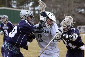 Dennis-Yarmouth's Ian Crosby gets through a Plymouth North double-team in yesterday's Dolphin victory at home. Phil Garceau Photo for Capecod.com Sports