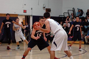 Apponequet's Stephen O'Malley makes a futile effort to contain Bourne School sophomore captain Jacob Ashworth who poured in a game-high 21 points last night to pace the Canalmen to a 54-53, nailbiting win on the road. Sean Walsh/capecod.com sports