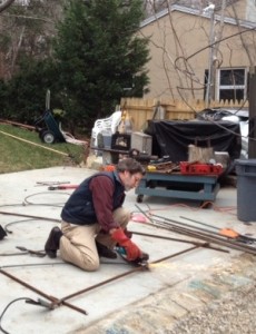 Michael Magyar at work on one of his "giants," which are large welded figures decorated with lights for the holidays. The figures can be seen along Route 6A.