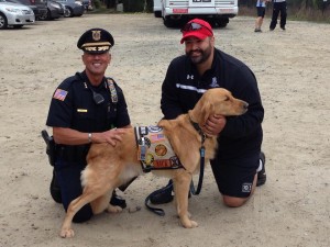 CAT WILSON/CCB MEDIA Army Veteran Curtis Frye of Falmouth (R) with his service dog Nick and Yarmouth Police Deputy Chief Steven Xiarhos (L). Nick is named after Xiarhos's son, Marine Cpl. Nicholas Xiarhos.