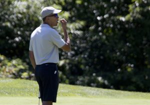 President Barack Obama gestures as he looks at the hole before putting on the first green during a round of golf at Farm Neck Golf Course in Oak Bluffs, Mass., on Martha's Vineyard, Sunday, Aug. 7, 2016. The president and his family are vacationing on the Massachusetts island of Martha's Vineyard. (AP Photo/Manuel Balce Ceneta)