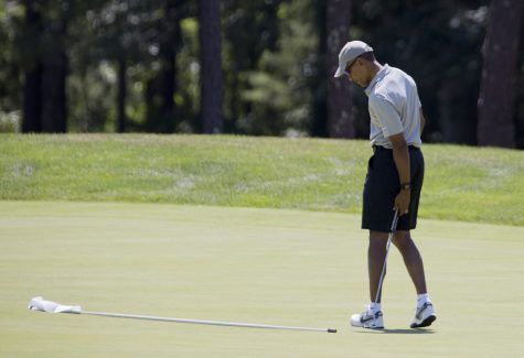 President Barack Obama checks the first hole near the flagstick during a round of golf at Farm Neck Golf Course in Oak Bluffs, Mass., on Martha's Vineyard, Sunday, Aug. 7, 2016. (AP Photo/Manuel Balce Ceneta)