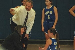 St. John Paul II senior captain Haley Whiteley is tended to by head coach Mike Tierney after rolling her ankle on a fast-break. Whiteley bounced right back to finish the night strong with 13 points. Sean Walsh/CCBM Sports