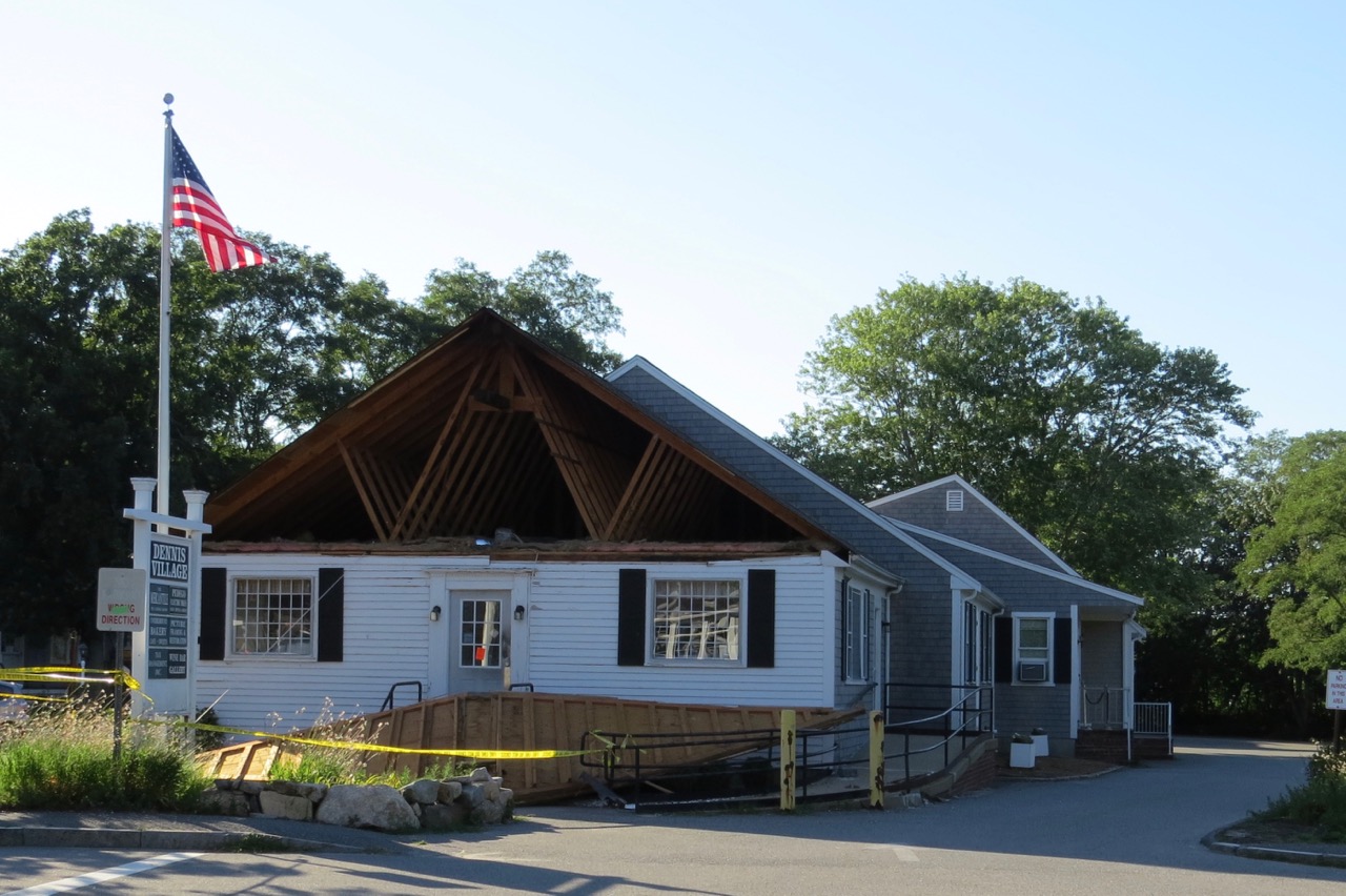 Video Truck hooks wires, yanks gable end off Dennis Post Office