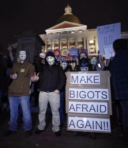 Protesters stand on the Mass. Statehouse steps in opposition of Donald Trump's presidential election victory in Boston, Wednesday evening, Nov. 9, 2016. (AP Photo/Charles Krupa)