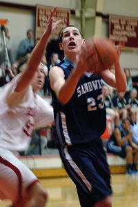 Sandwich High's Andrew Galanek blows by Barnstable's Eric Holzman in last night's 63-59 win for the Blue Knights. Sean Walsh/capecod.com sports