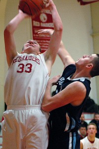 Barnstable;s Will O'Day (33) poured in a team-high 20 points as Sandwich senior co-captain Hank O'Brien tries to stop him. O'Brien had 12 points on the night. Sean Walsh/capecod.com sports