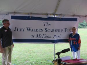CCB MEDIA PHOTO: Former Cape Cod Baseball League President Judy Walden Scarafile thanks her husband, Peter, for his support over the years during a ceremony re-naming McKeon Field in Hyannis in her honor.