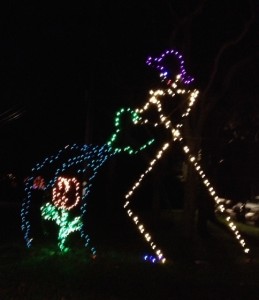 One of the "giants" crafted by Michael Magyar is a gardener watering a flower in front of the store Scenic Roots.