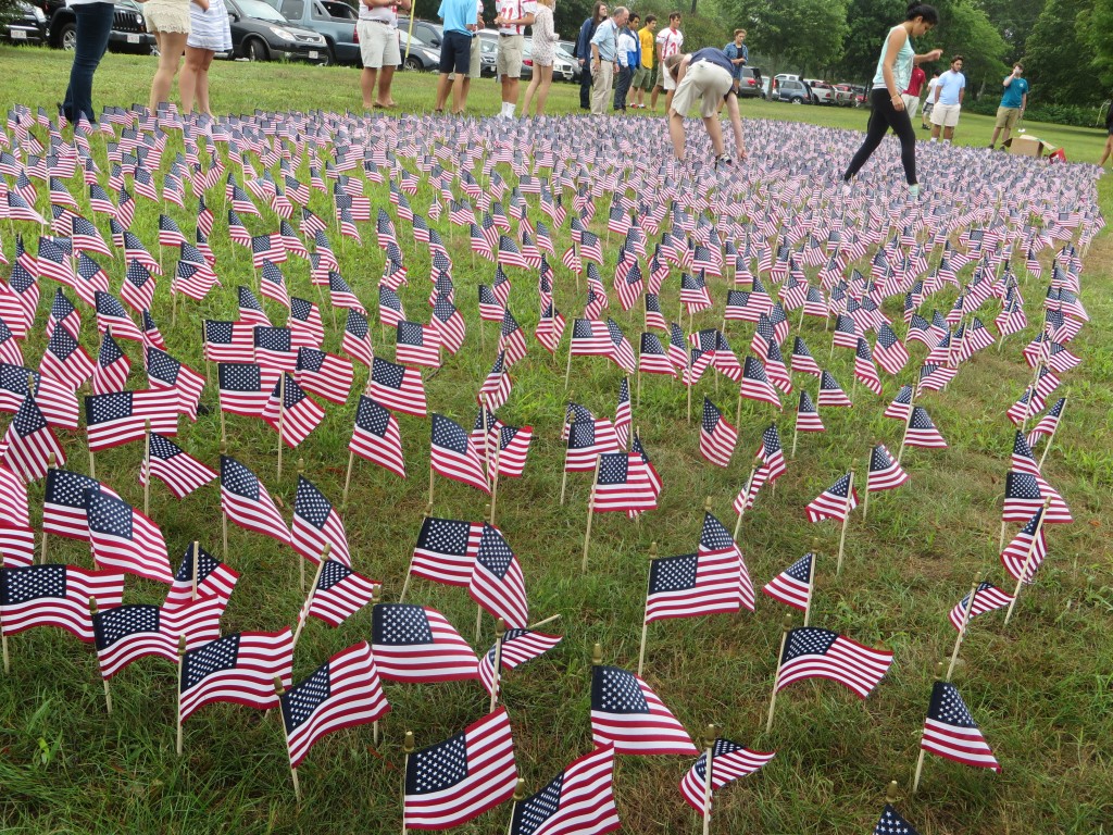 CCB MEDIA PHOTO Barnstable High School students place flags in front of the high school Friday to mark the September 11 terror attacks