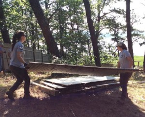 COURTESY OF THE WELLFLEET CONSERVATION TRUST AmeriCorps members Sasha Berns and Natalie Wall remove sections of the "spite fence" in South Wellfleet.
