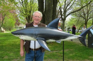 COURTESY PHOTO: RICH BENSON Chatham artist  Rich Benson poses with shark he created.  The sculpture was stolen Thursday night.