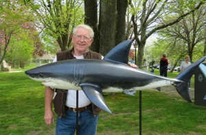 COURTESY PHOTO: RICH BENSON Chatham artist Rich Benson poses with shark he created. The sculpture was stolen Thursday night.