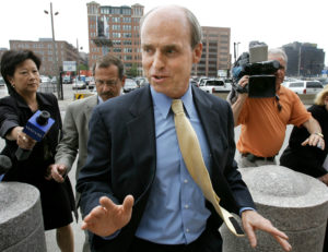 FILE - In this June 14, 2005, file photo, former Massachusetts House Speaker Thomas Finneran, center, walks past members of the media as he enters federal court in Boston. The Mass. Supreme Judicial Court is set to hear arguments in a long-running dispute over whether Finneran should be able to receive his retirement pension despite his criminal conviction for obstruction of justice. (AP Photo/Steven Senne, File)
