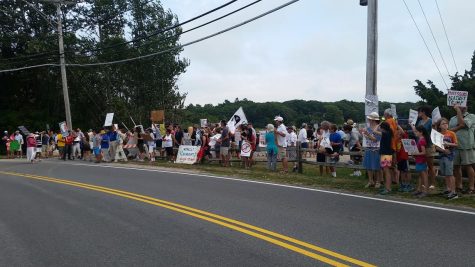 CCB MEDIA PHOTO: Protesters line Bridge St. in Osterville in advance of Donald Trump's visit Saturday