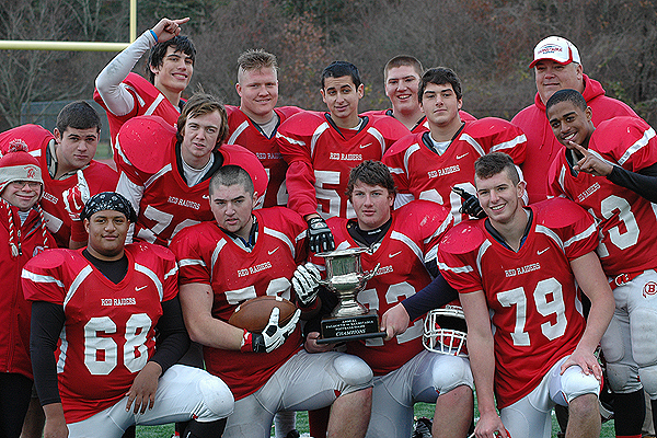 The proud defensive linemen for Barnstable High pose with The Selectmen's Cup after beating Falmouth for a 6th straight season, 34-27. Photo by Sean Walsh/CCBM Sports