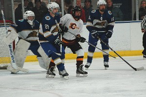 Gil Bach (30), Matt Aylmer (20) and Danny Mazzola (10) of St. John Paul II surround Cape Tech/CC Academy's David Carty in the first period of Saturday night's 4-1 CC Tech/CCA victory. Sean Walsh/CCBM Sports