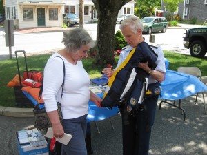 CCB MEDIA PHOTO US Coast Guard Auxiliary Commodore Carolyn Belmore instructs an attendee on the use of a personal flotation device.
