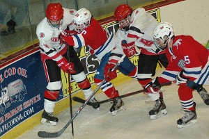 Barnstable's Connor Rainville and Matt Pasic battle Burlington senior captain Adam Morgan and Tommy Hanafin for the puck in Burlington's 3-2 win in Hyannis Monday afternoon. Sean Walsh/www.capecod.com sports