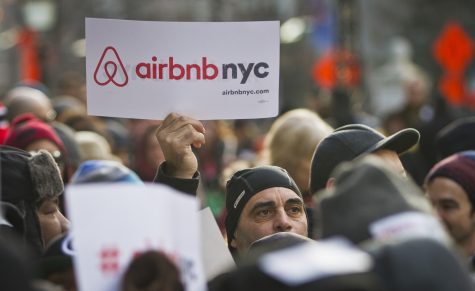 Supporters of Airbnb hold a rally outside City Hall, Tuesday, Jan. 20, 2015, in New York. With home-as-hotel sites like Airbnb doing booming business, New York City lawmakers are holding a hearing to scrutinizing how the trend affects the housing market and economy. (AP Photo/Bebeto Matthews)