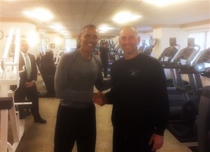 In this photo provided by the Boston Red Sox, President Barack Obama, left, shakes hands with Boston Red Sox Interim Manager Torey Lovullo in the exercise room of the New York Palace Hotel, Tuesday, Sept. 29, 2015, in New York. (Mike Hazen/Boston Red Sox via AP) MANDATORY CREDIT
