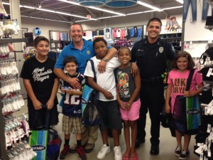 Officers and students at Old Navy for "Back to School Shop with a Cop" Wednesday.