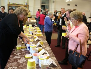 CCB MEDIA PHOTO Lynne Poyant, Barnstable Director of Community Services, helps to serve ice cream to visitors from Barnstaple, England, during an informal reception at Barnstable Town Hall.