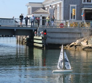 CCB MEDIA PHOTO Spectators watch a model boat race from the drawbridge in Woods Hole.