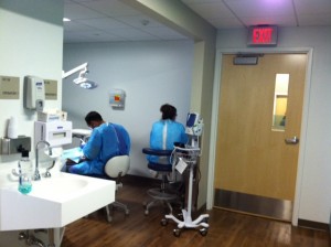 Staff work on a patient in the dental area of the new Harbor Community Health Center.