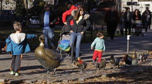 In this Nov. 18, 2016, photo, a boy points at a sculpture of a mother duck and her ducklings, based on the classic children's story "Make Way for Ducklings" at the Boston Public Garden in Boston. A new exhibition at the Museum of Fine Arts is devoted to Robert McCloskey, the award-winning author of 1941's "Make Way for Ducklings" and other children's classics. (AP Photo/Charles Krupa)