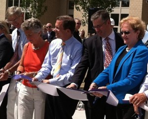 Steve Grossman (center) was among a host of officials at the ribbon cutting for the new Monomoy School in Chatham last month.