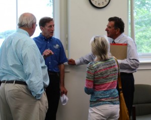 CCB MEDIA PHOTO Barnstable Town Manager Tom Lynch, right, talks to Michael Sweeney and Nancy Davidson of Housing Assistance Corporation, and Robert Ciolek, left, who vice chairman on the HAC board.