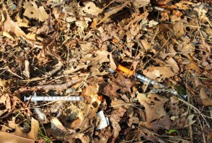 CCB MEDIA PHOTO Used needles strewn on the ground near a campsite in Hyannis.